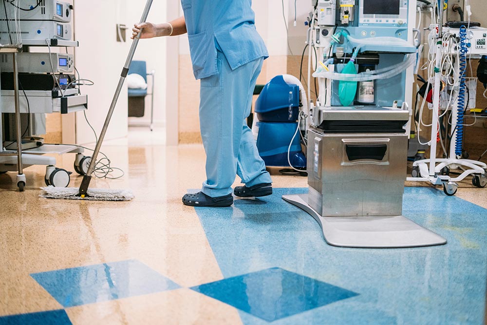 A hospital worker doing cleaning in operation room