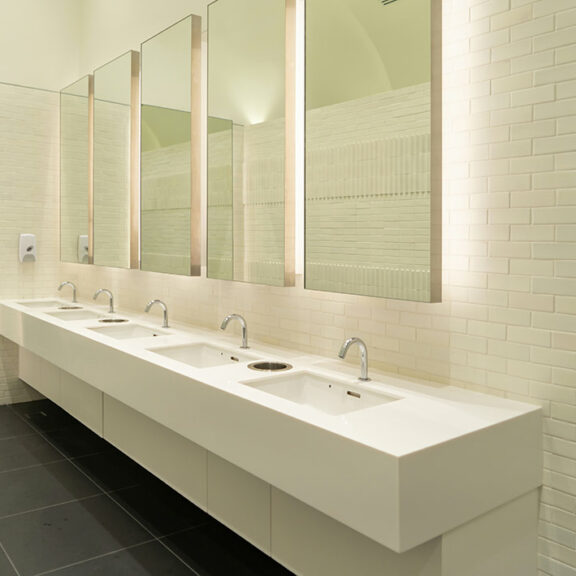 Row of white modern marble ceramic wash basin in public toilet, restroom in office